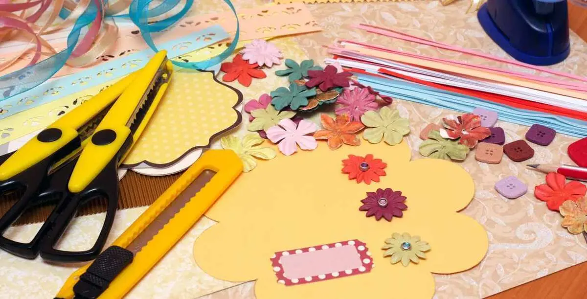 hand made scrapbooking post card and tools lying on a table