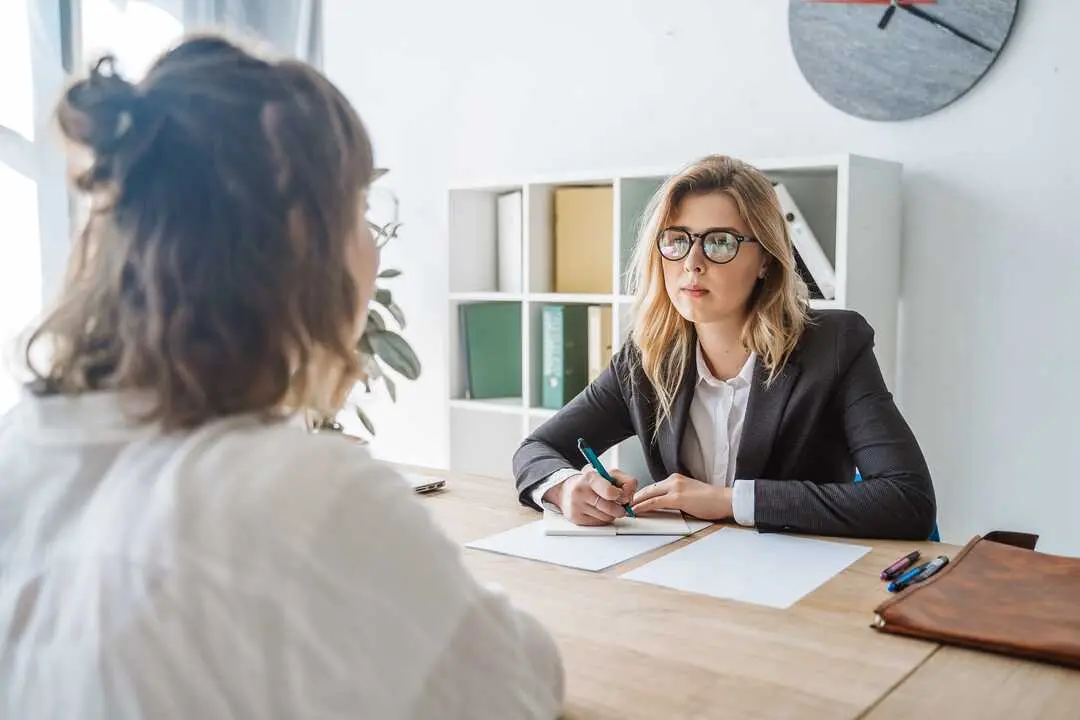 Young female candidate is interviewed by employer businesswoman