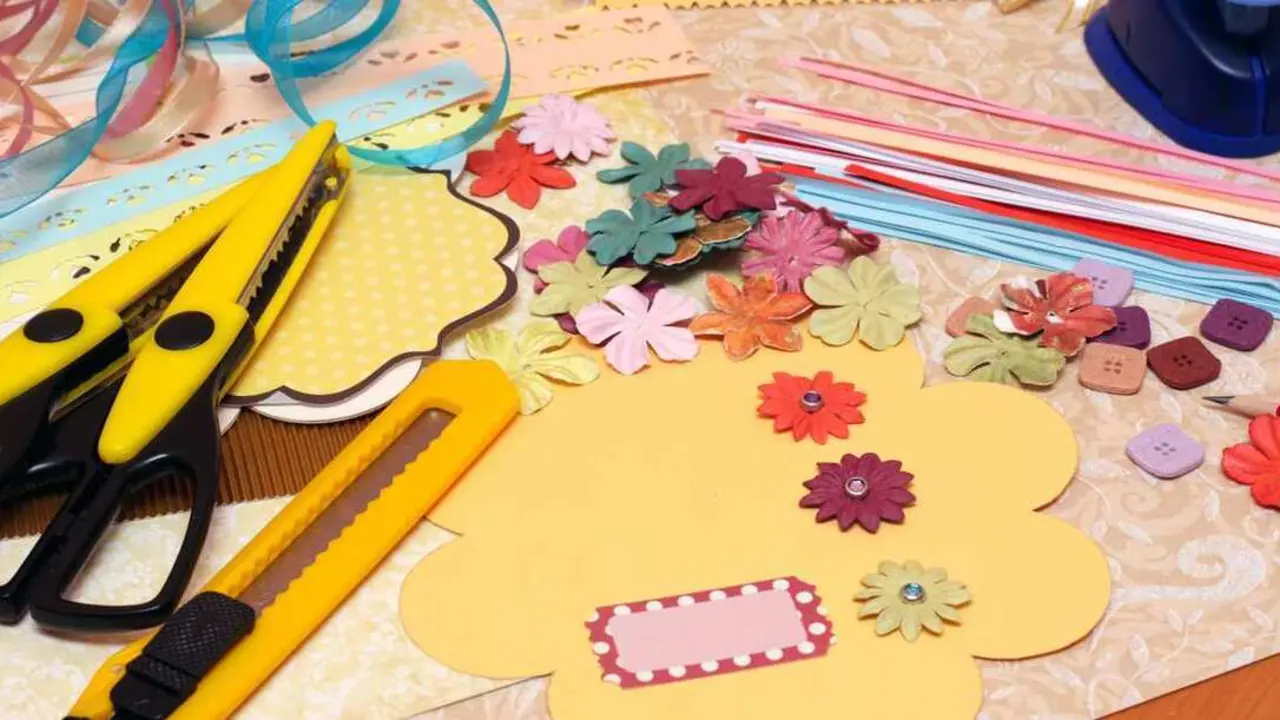 hand made scrapbooking post card and tools lying on a table