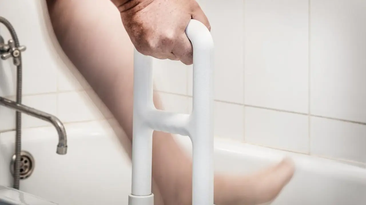 hand holding handrail for the disabled and the elder in the bathroom