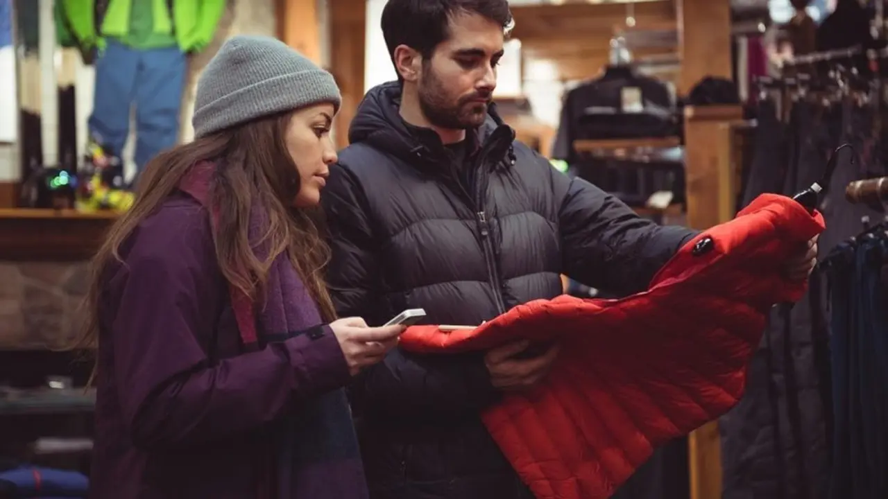 Couple selecting apparel together in a clothes shop