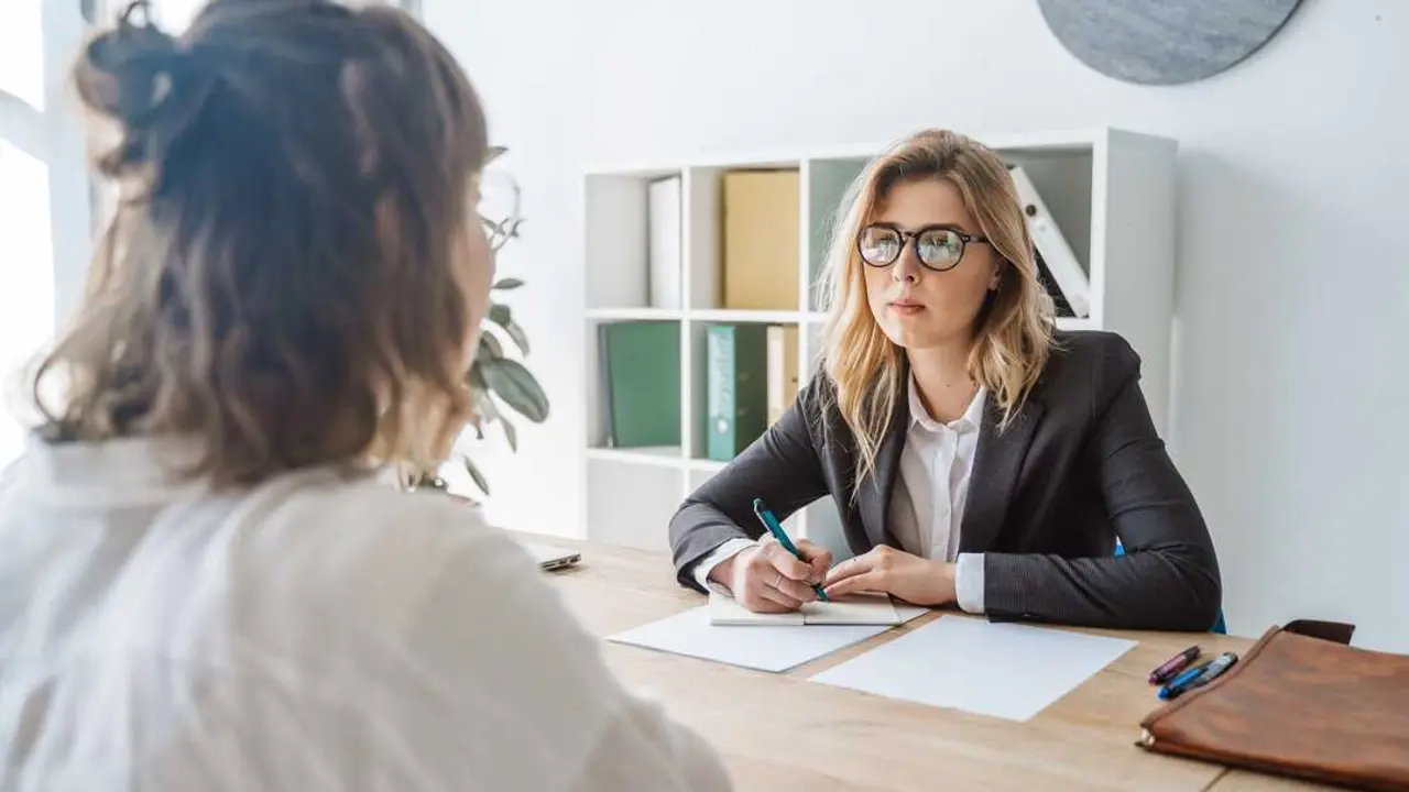 Young female candidate is interviewed by employer businesswoman